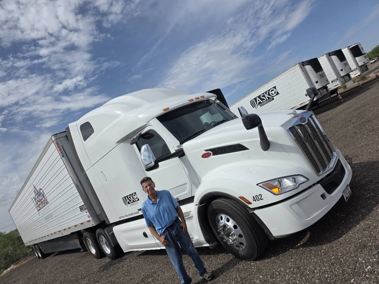 Ira Bardmess beside a white JASKO tractor